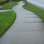 sidewalk with landscaped edging grass